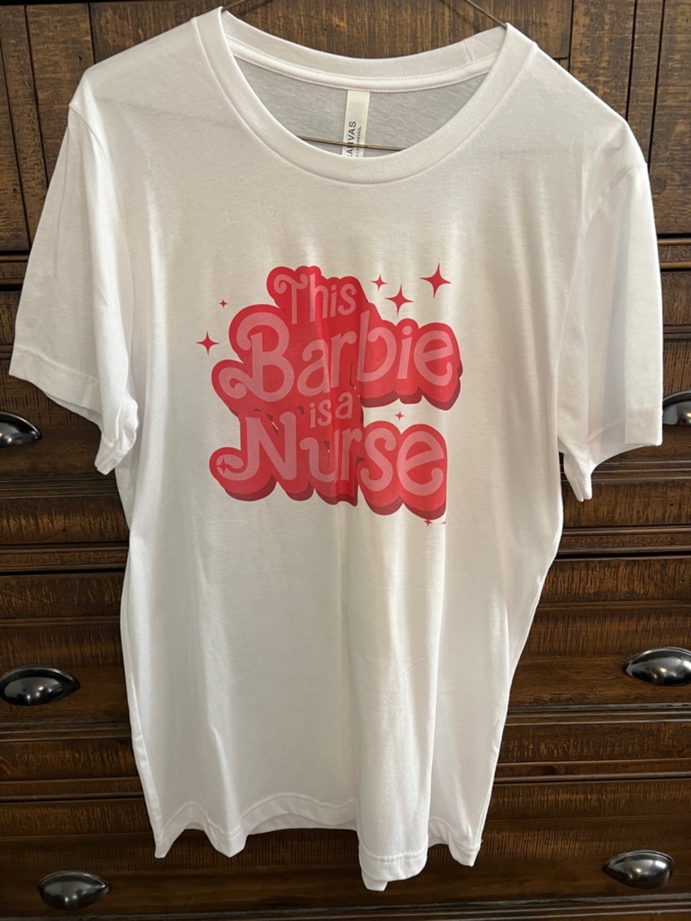 White Graphic Tee with Pink 'This Barbie is a Nurse' Print